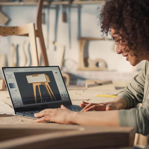 Woodcraft Artist Working on Laptop Computer, Creating a Digital