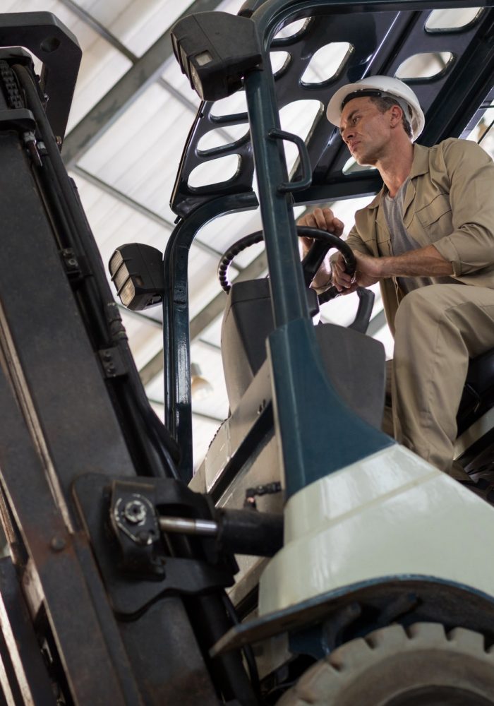 Worker driving forklift Worker driving forklift